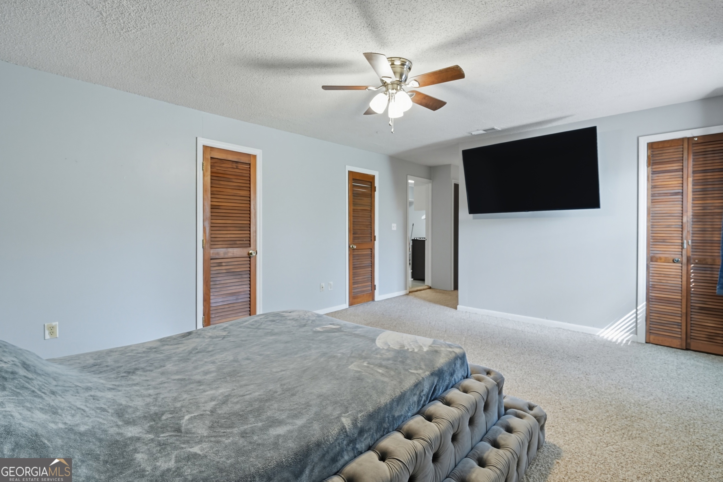 757 Old Screven Road Jesup, GA 31545 - Photo 16 of 38 a bedroom with a bed and a flat screen tv