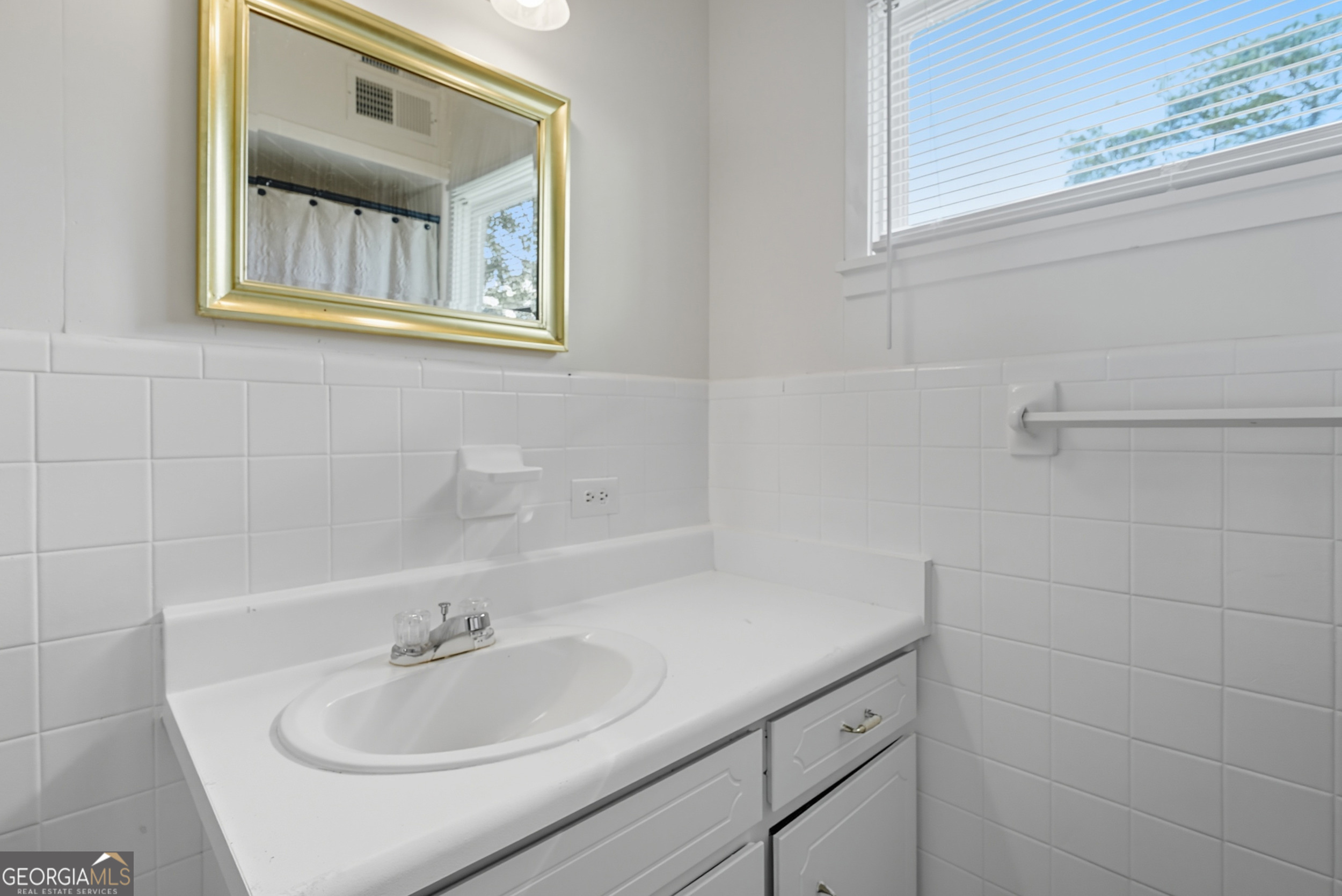 757 Old Screven Road Jesup, GA 31545 - Photo 29 of 38 a bathroom with a sink and a mirror