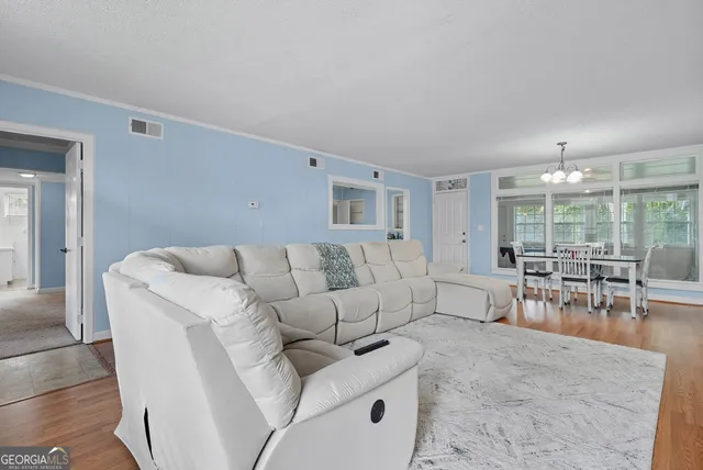 a living room with furniture and large windows