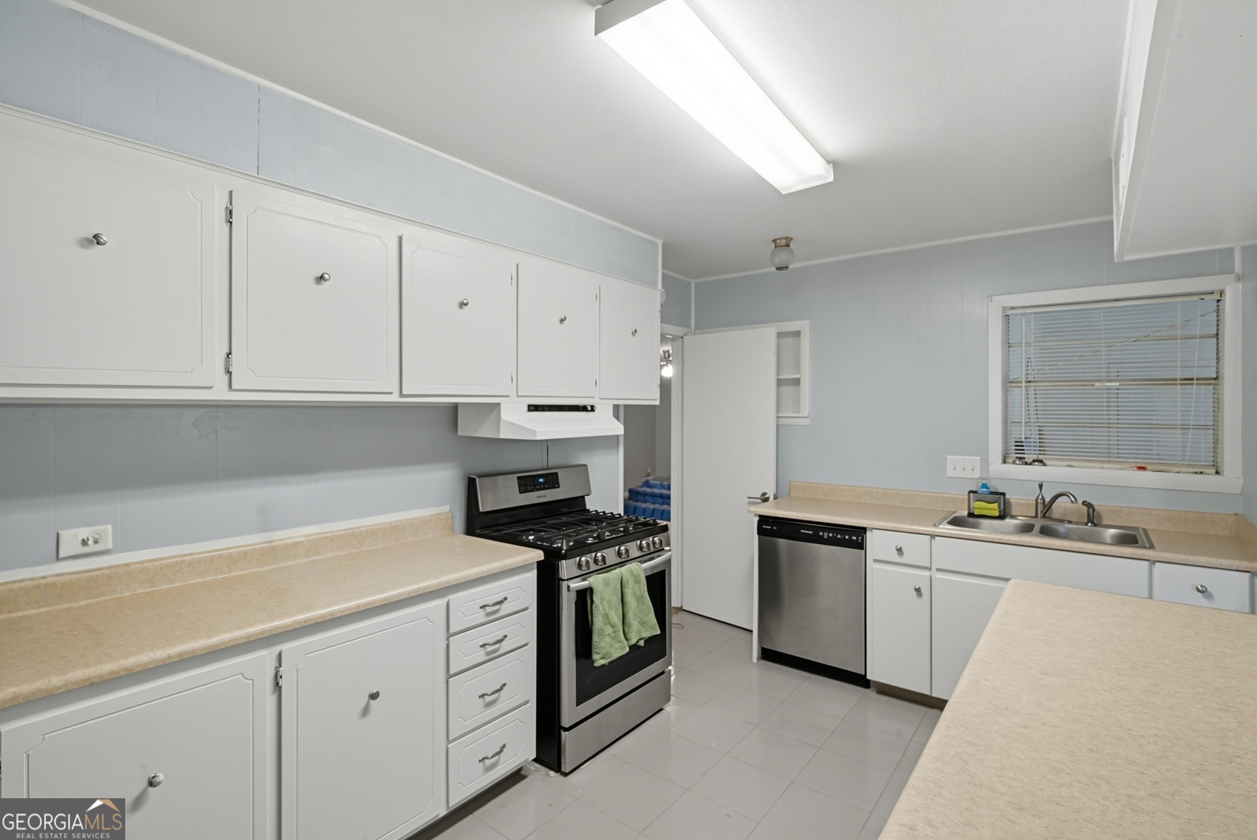 757 Old Screven Road Jesup, GA 31545 - Photo 10 of 38 a kitchen with white cabinets sink and white appliances