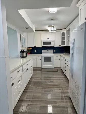 a kitchen with a table chairs and a sink
