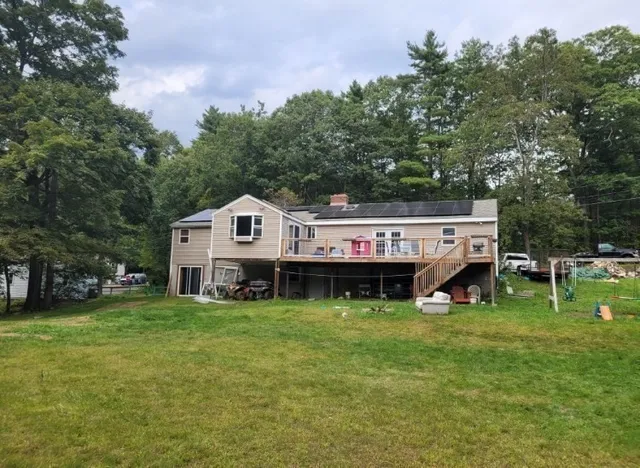 a view of a house with a yard and sitting area