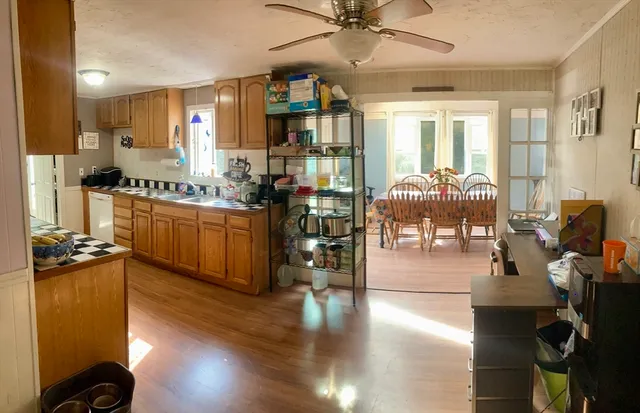 a kitchen with stainless steel appliances kitchen island granite countertop a stove and cabinets