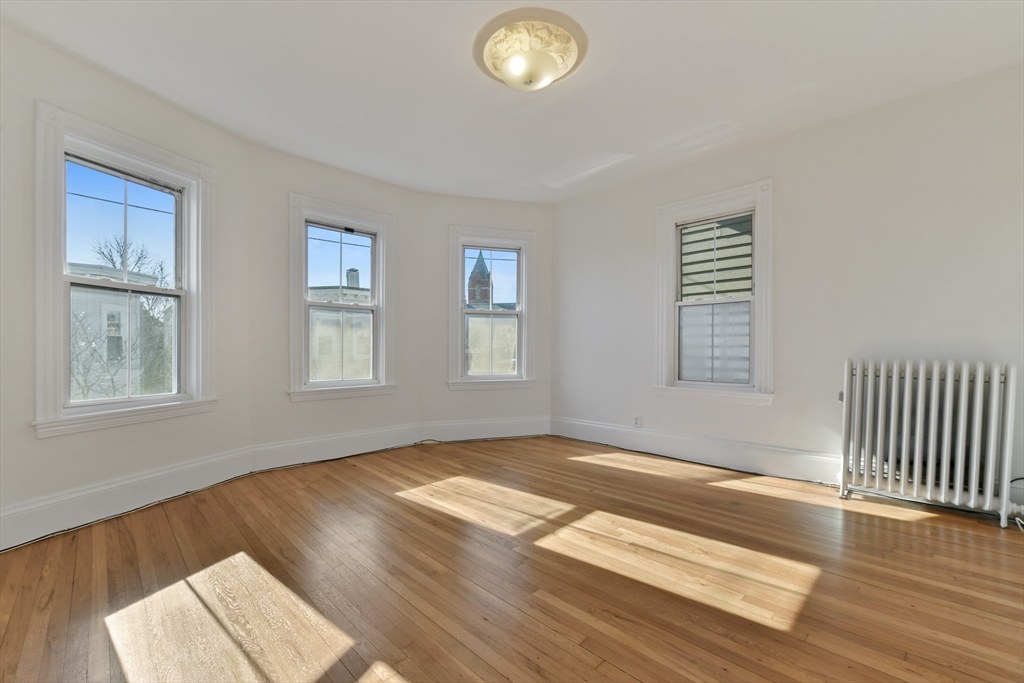 50 Mt Vernon Street, Unit 3 Boston, MA 02125 - Photo 5 of 16 a view of an empty room with wooden floor and a window