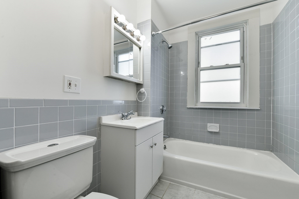 50 Mt Vernon Street, Unit 3 Boston, MA 02125 - Photo 6 of 16 a bathroom with a sink a toilet and bathtub