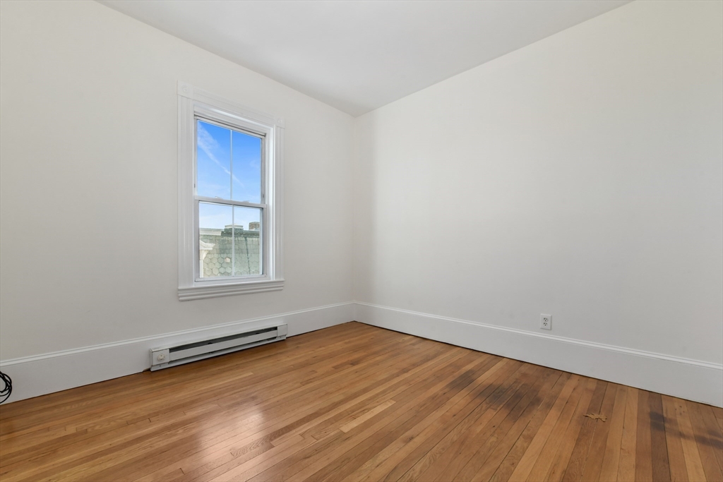 50 Mt Vernon Street, Unit 3 Boston, MA 02125 - Photo 8 of 16 an empty room with wooden floor and windows