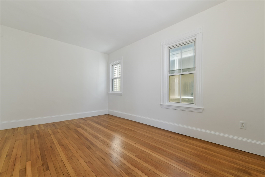 50 Mt Vernon Street, Unit 3 Boston, MA 02125 - Photo 9 of 16 a view of an empty room with wooden floor and a window