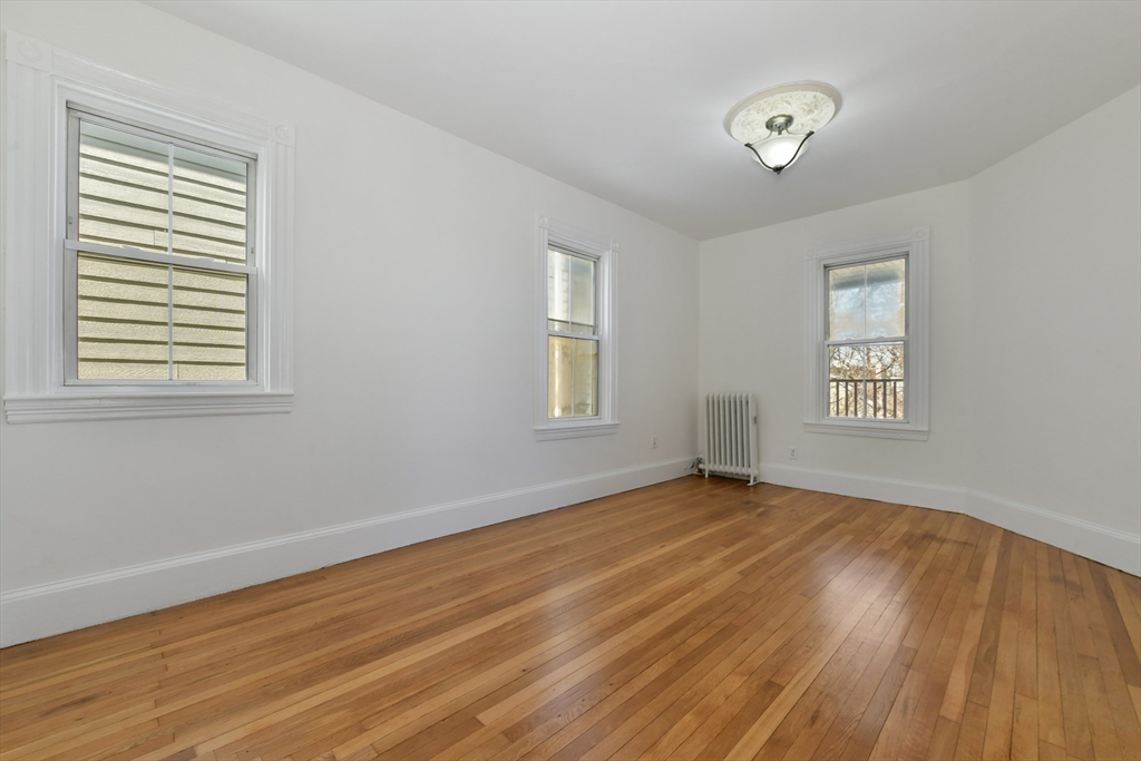 50 Mt Vernon Street, Unit 3 Boston, MA 02125 - Photo 10 of 16 a view of an empty room with wooden floor and a window