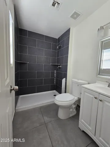 a bathroom with a toilet a sink and shower