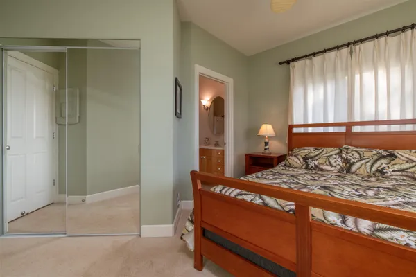 a bedroom with a bed and a lamp
