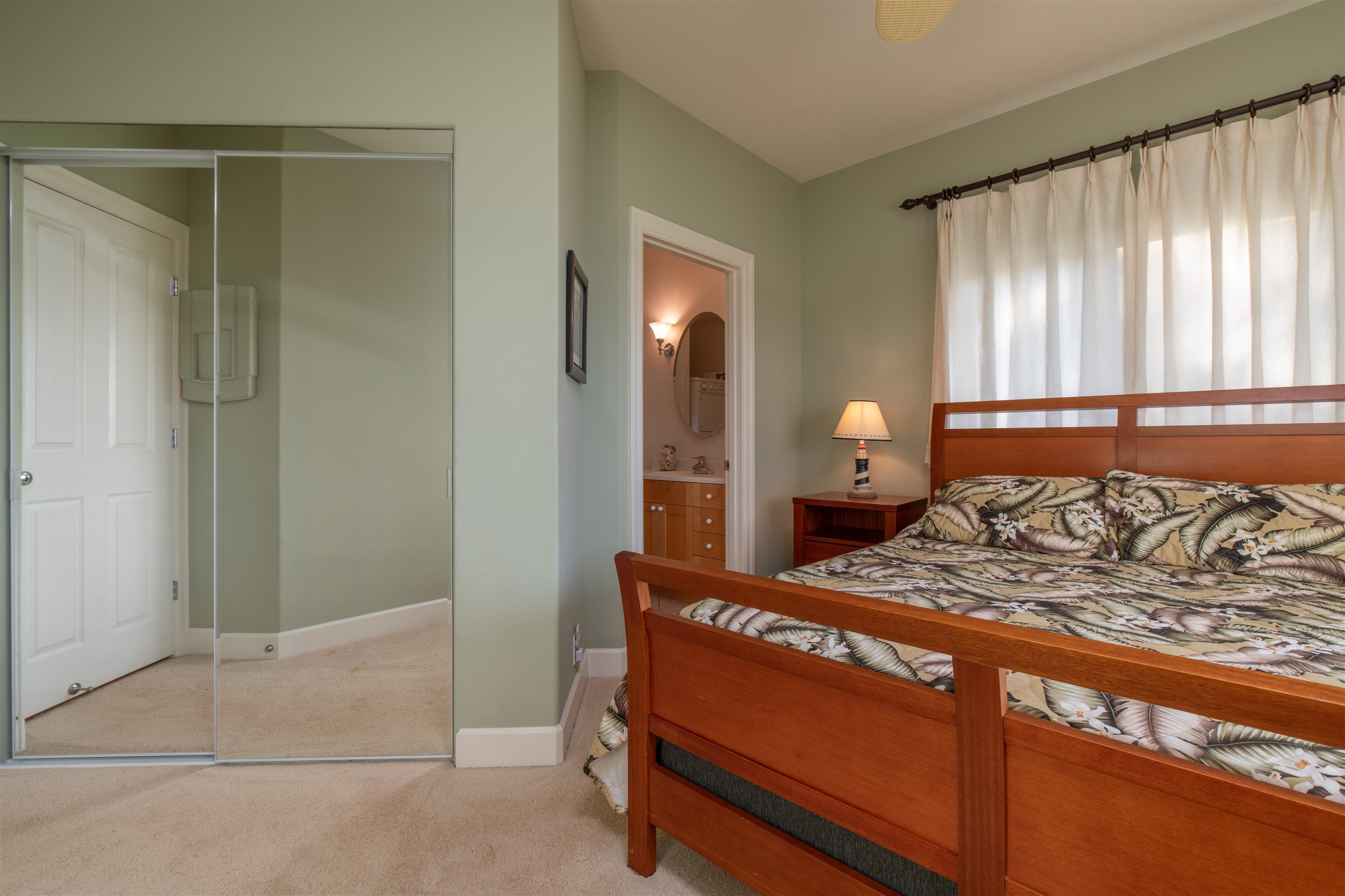 2345 Omaopio Road Kula, HI 96790 - Photo 16 of 23 a bedroom with a bed and a lamp