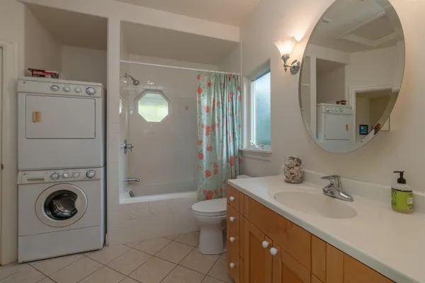 a bathroom with a sink mirror vanity and toilet