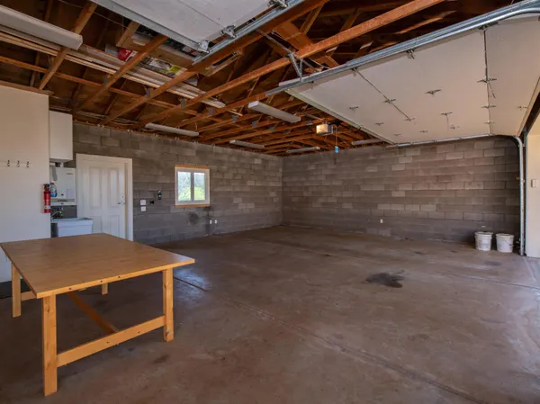 a room with pool table and windows