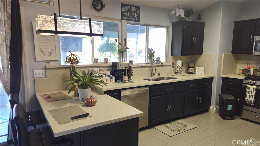 15274 Rodeo Street Hesperia, CA 92345 - Photo 18 of 43 a kitchen with a sink appliances and a counter top space