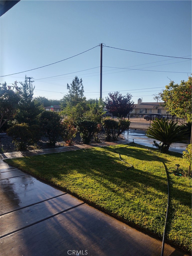 15274 Rodeo Street Hesperia, CA 92345 - Photo 2 of 43 a view of a swimming pool with a garden