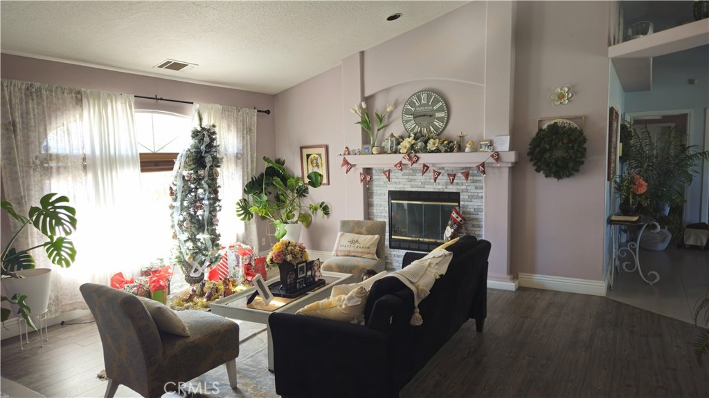 15274 Rodeo Street Hesperia, CA 92345 - Photo 23 of 43 a living room with furniture and a fireplace