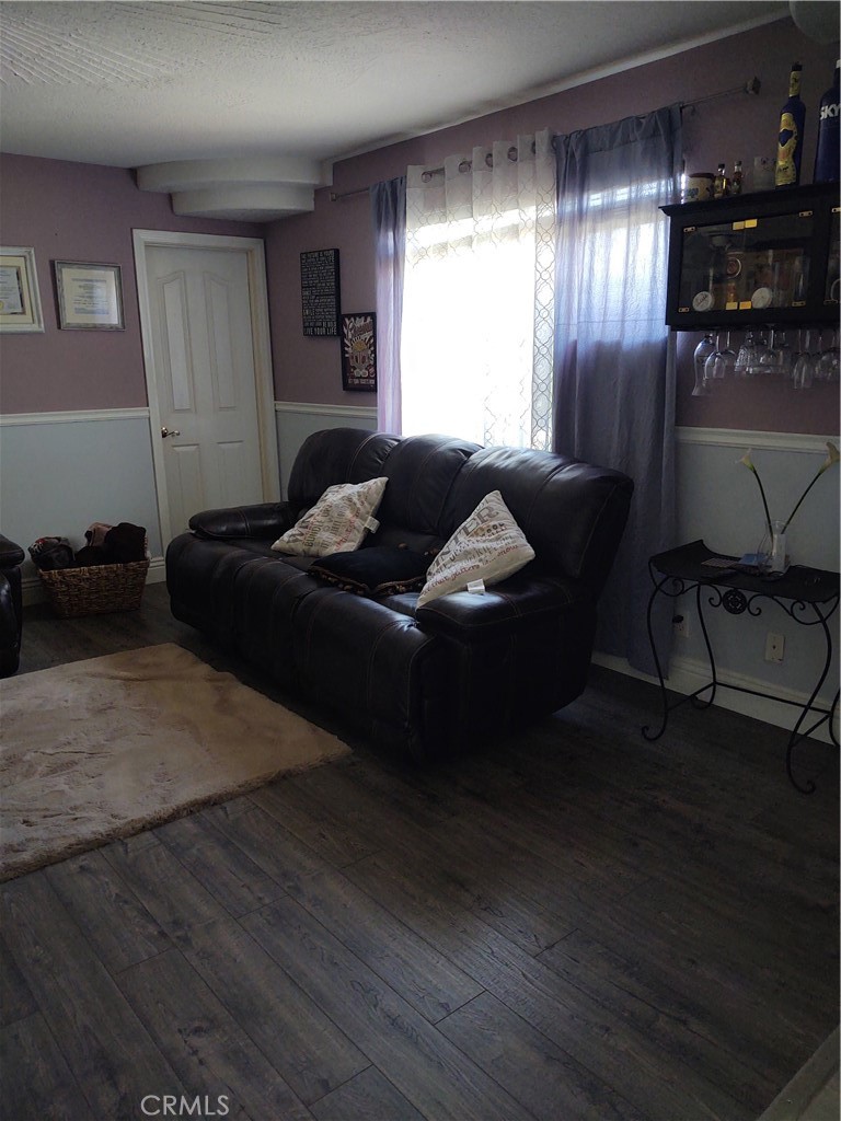 15274 Rodeo Street Hesperia, CA 92345 - Photo 24 of 43 a living room with furniture and a chandelier