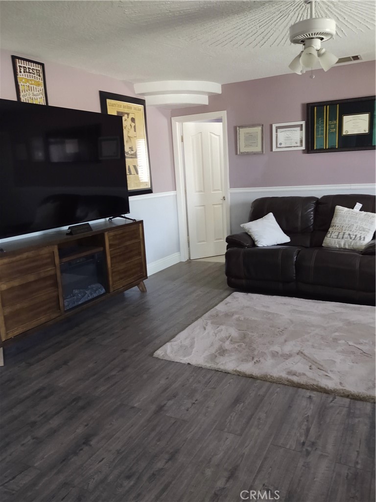 15274 Rodeo Street Hesperia, CA 92345 - Photo 25 of 43 a living room with furniture and a flat screen tv