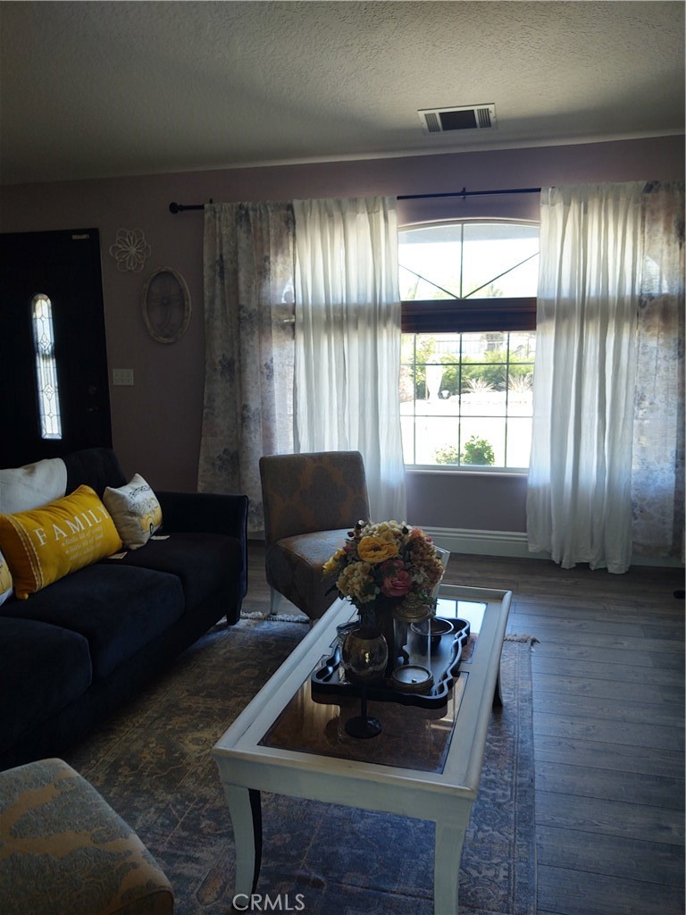 15274 Rodeo Street Hesperia, CA 92345 - Photo 26 of 43 a living room with furniture and a chandelier