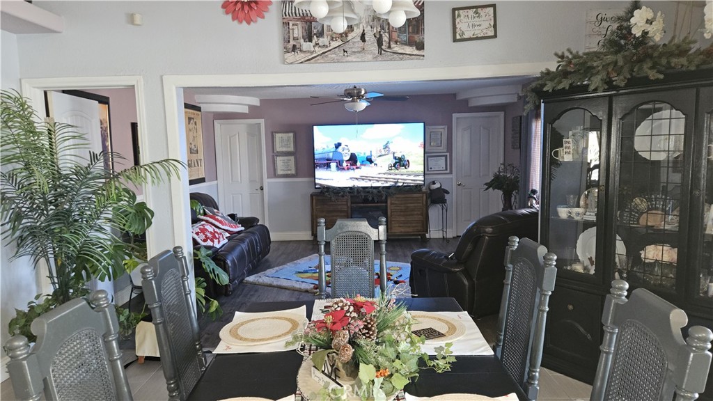 15274 Rodeo Street Hesperia, CA 92345 - Photo 30 of 43 a dining room with furniture a rug and wooden floor
