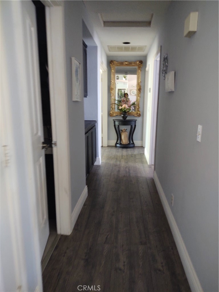 15274 Rodeo Street Hesperia, CA 92345 - Photo 33 of 43 a view of a hallway and wooden floor a livingroom with furniture