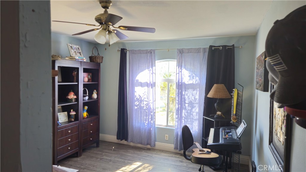 15274 Rodeo Street Hesperia, CA 92345 - Photo 37 of 43 a view of a livingroom with workspace and a window