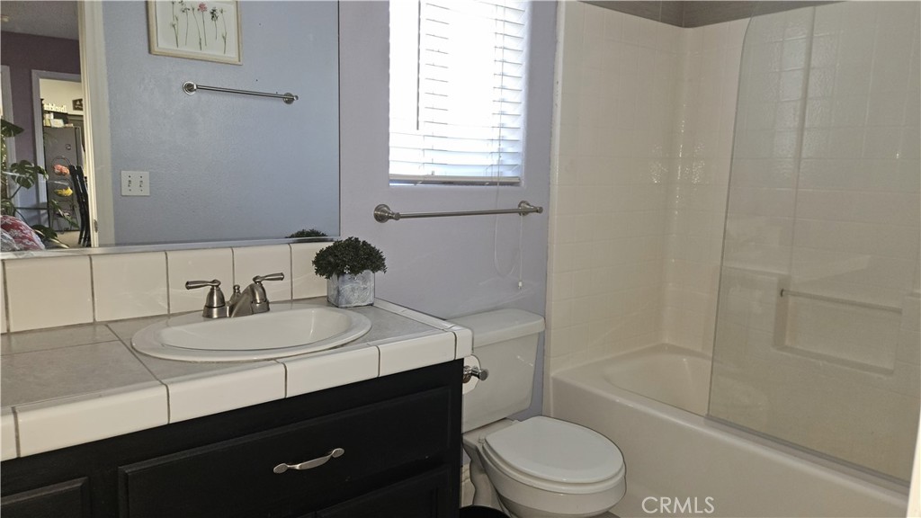 15274 Rodeo Street Hesperia, CA 92345 - Photo 40 of 43 a bathroom with a sink a toilet and shower