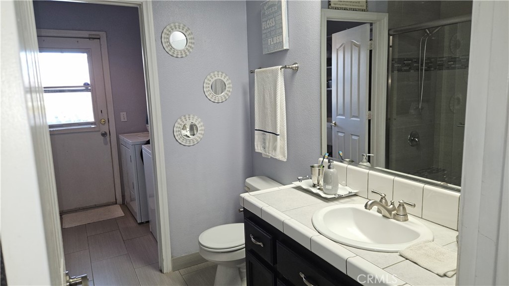 15274 Rodeo Street Hesperia, CA 92345 - Photo 42 of 43 a bathroom with a sink and a mirror