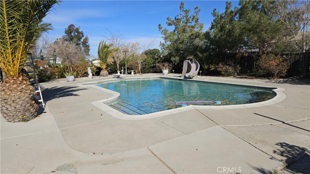 15274 Rodeo Street Hesperia, CA 92345 - Photo 7 of 43 a view of a swimming pool with outdoor seating