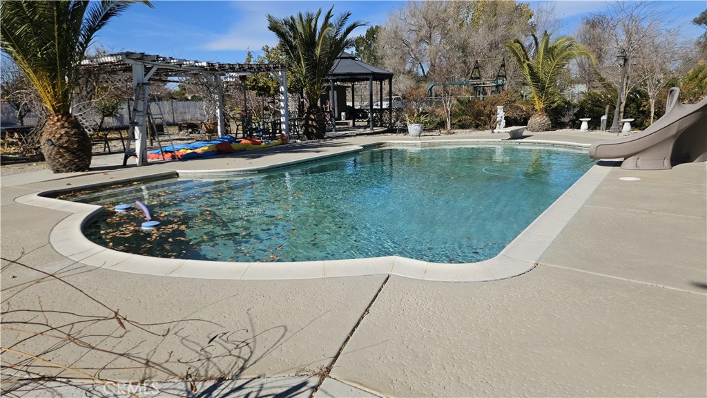 15274 Rodeo Street Hesperia, CA 92345 - Photo 8 of 43 a view of swimming pool with a yard