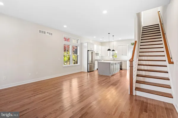 a view of a kitchen with furniture and wooden floor
