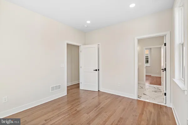 a spacious bathroom with a sink mirror vanity and a toilet