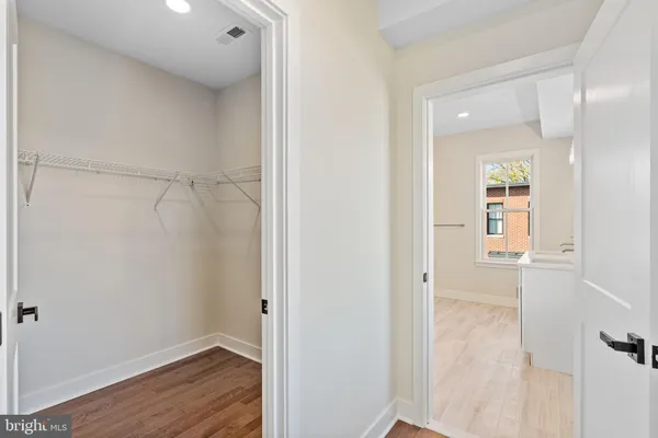 a bathroom with a sink mirror and a shower