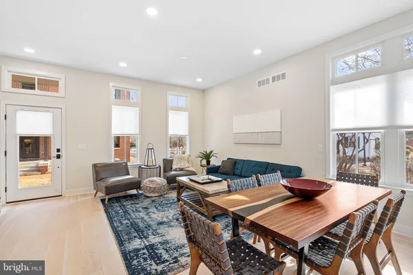 a living room with furniture a rug and a window