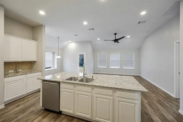 a view of kitchen with sink and wooden floor