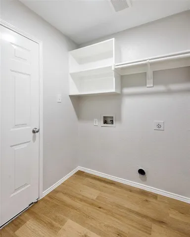 an empty room with windows and ceiling fan