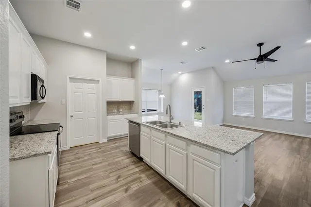 a bathroom with a sink toilet vanity and shower