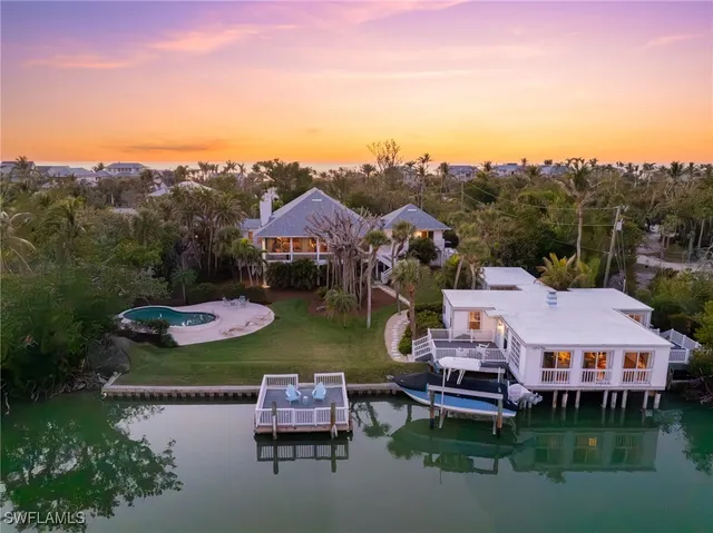 an aerial view of a house with garden space and lake view