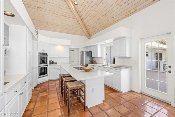 a kitchen with stainless steel appliances kitchen island granite countertop a sink and cabinets