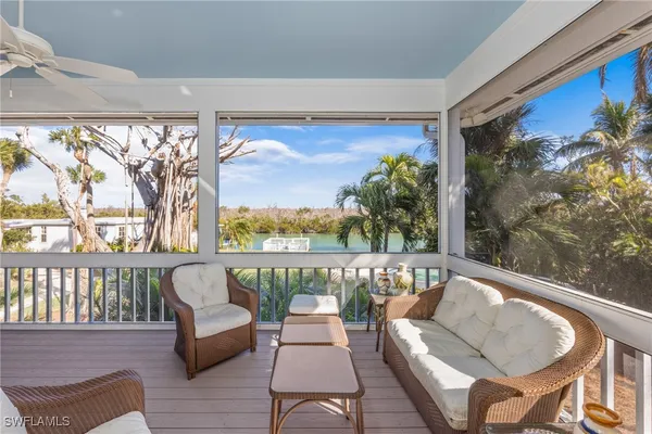 a roof deck with couches and wooden floor
