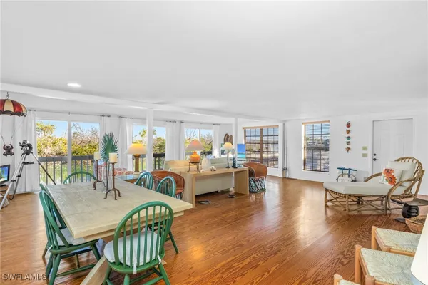 a dining room with furniture wooden floor and a rug