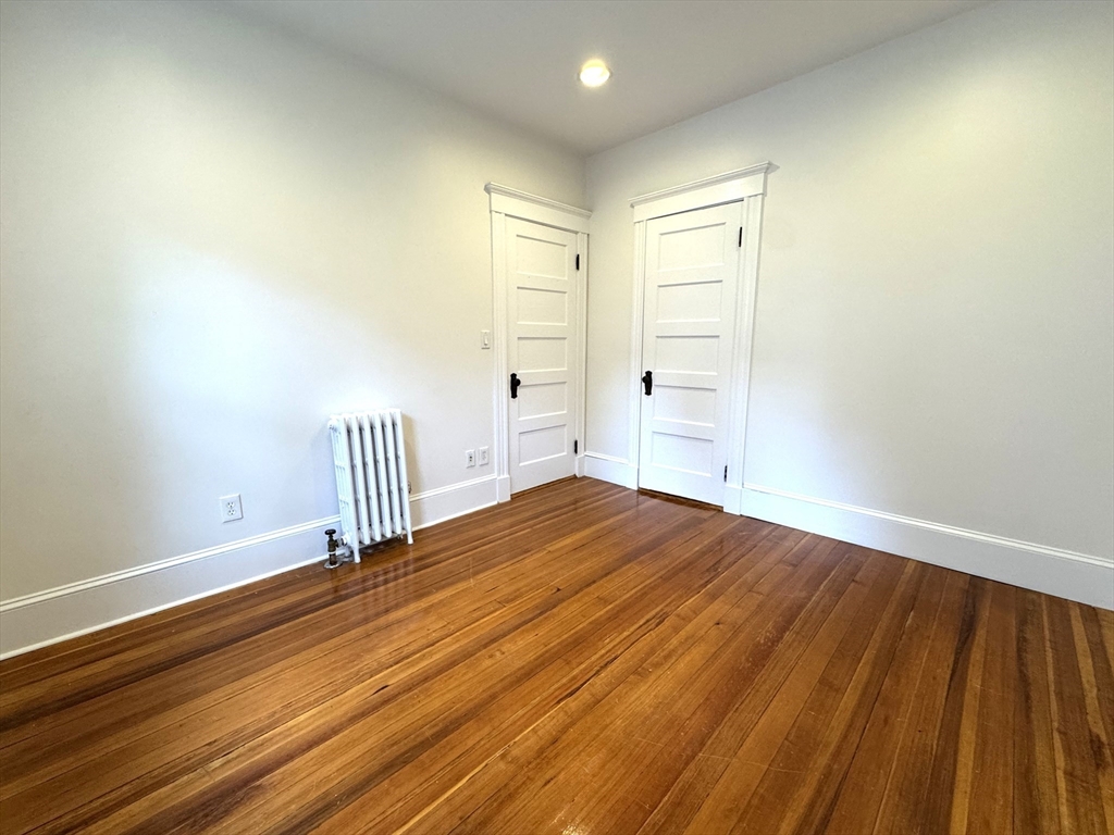 14 Breck Avenue, Unit 2 Boston, MA 02135 - Photo 13 of 26 a view of a room with wooden floor and white walls