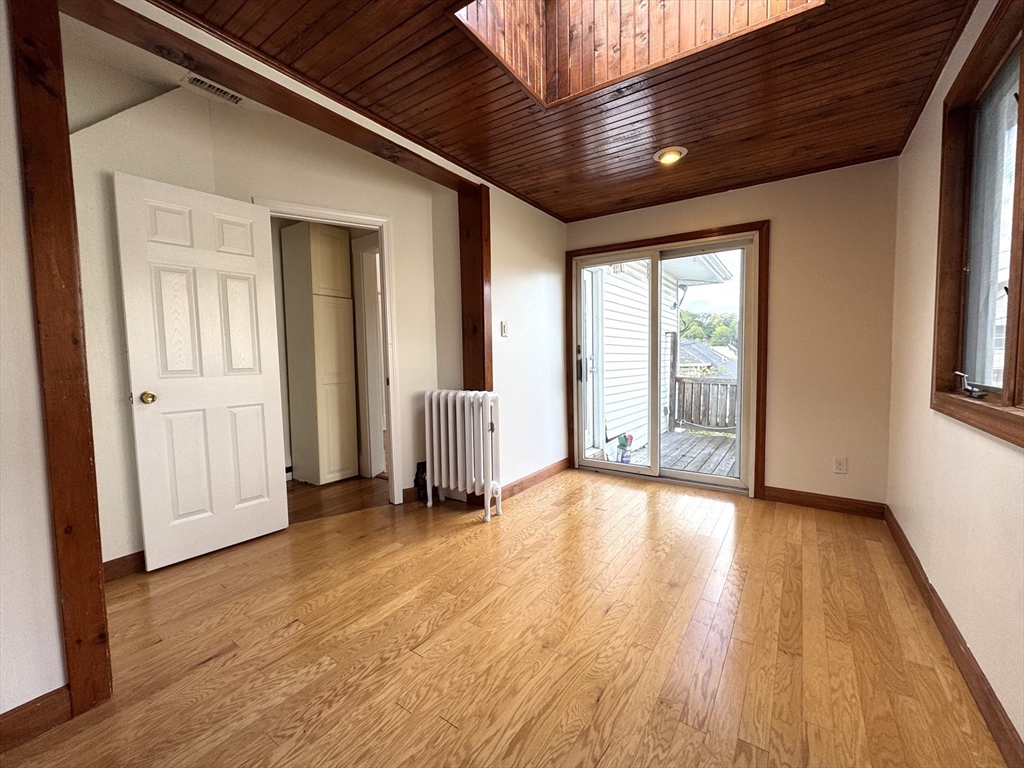 14 Breck Avenue, Unit 2 Boston, MA 02135 - Photo 17 of 26 a view of an empty room with wooden floor and a window