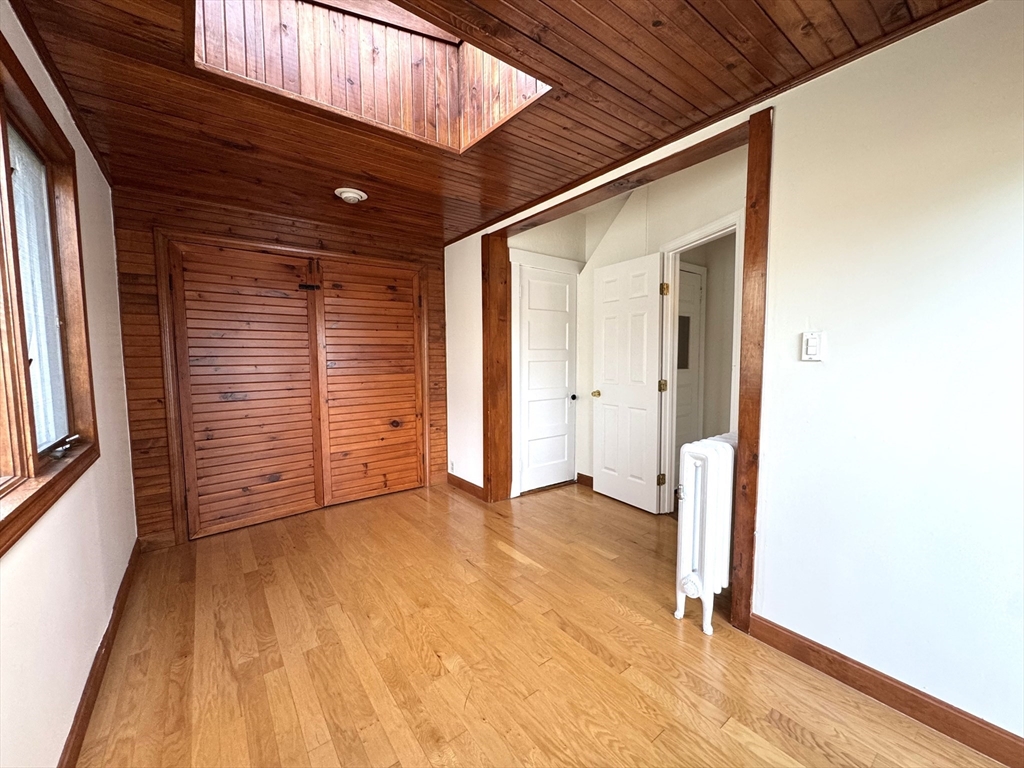 14 Breck Avenue, Unit 2 Boston, MA 02135 - Photo 18 of 26 a view of an empty room with wooden floor and a window