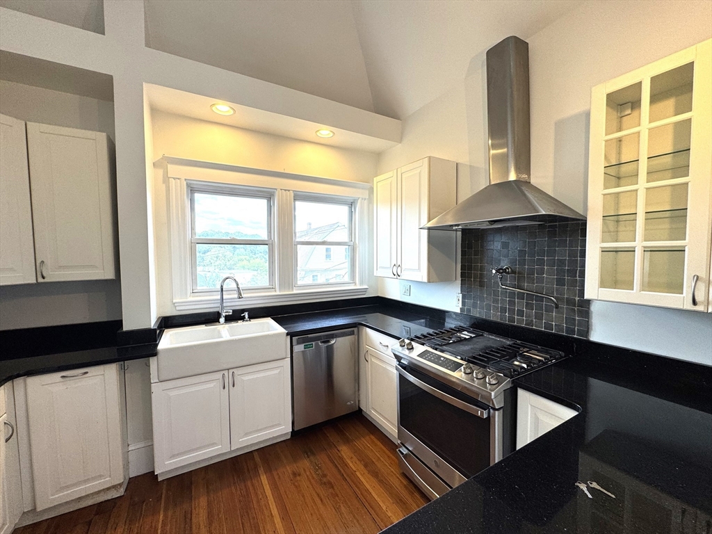 14 Breck Avenue, Unit 2 Boston, MA 02135 - Photo 2 of 26 a kitchen with granite countertop a sink a stove and cabinets