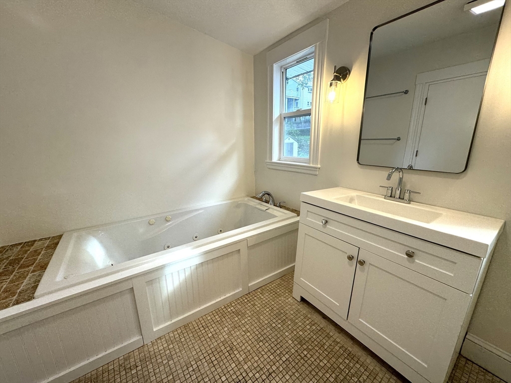 14 Breck Avenue, Unit 2 Boston, MA 02135 - Photo 22 of 26 a bathroom with a sink and a mirror