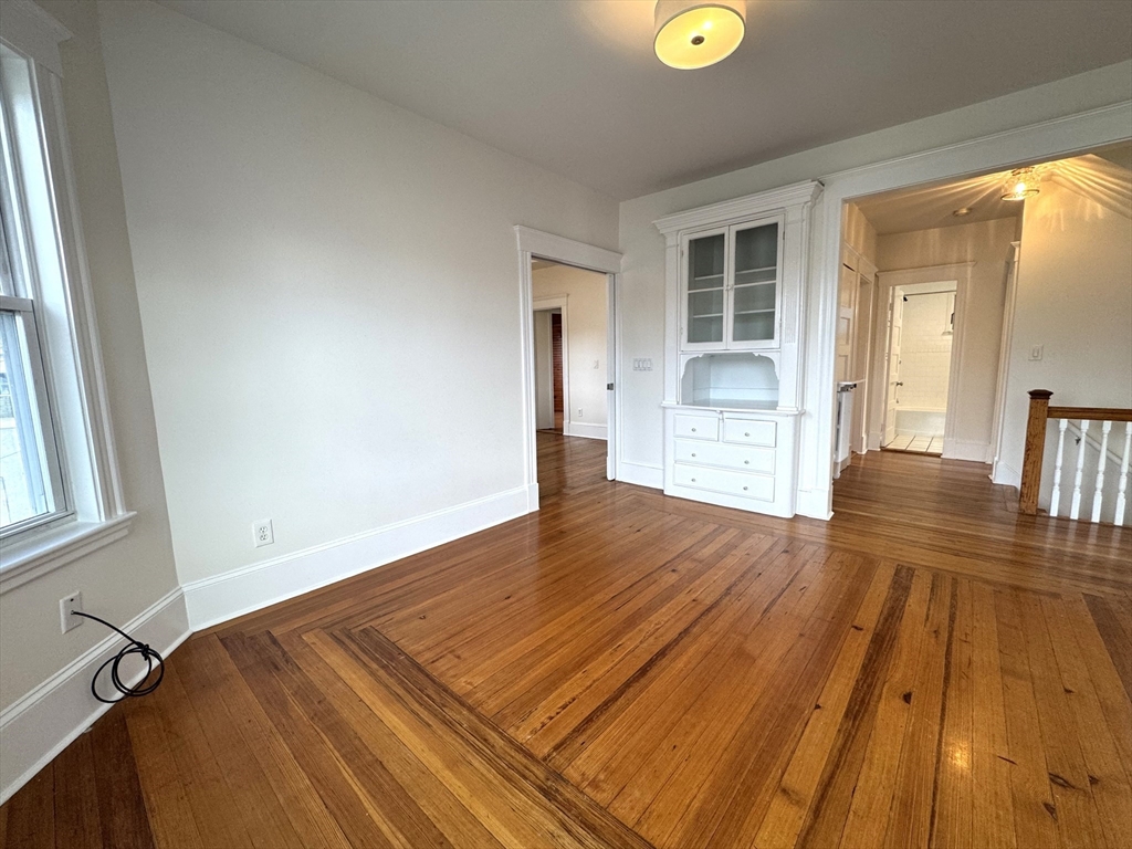 14 Breck Avenue, Unit 2 Boston, MA 02135 - Photo 5 of 26 a view of empty room with wooden floor and fan