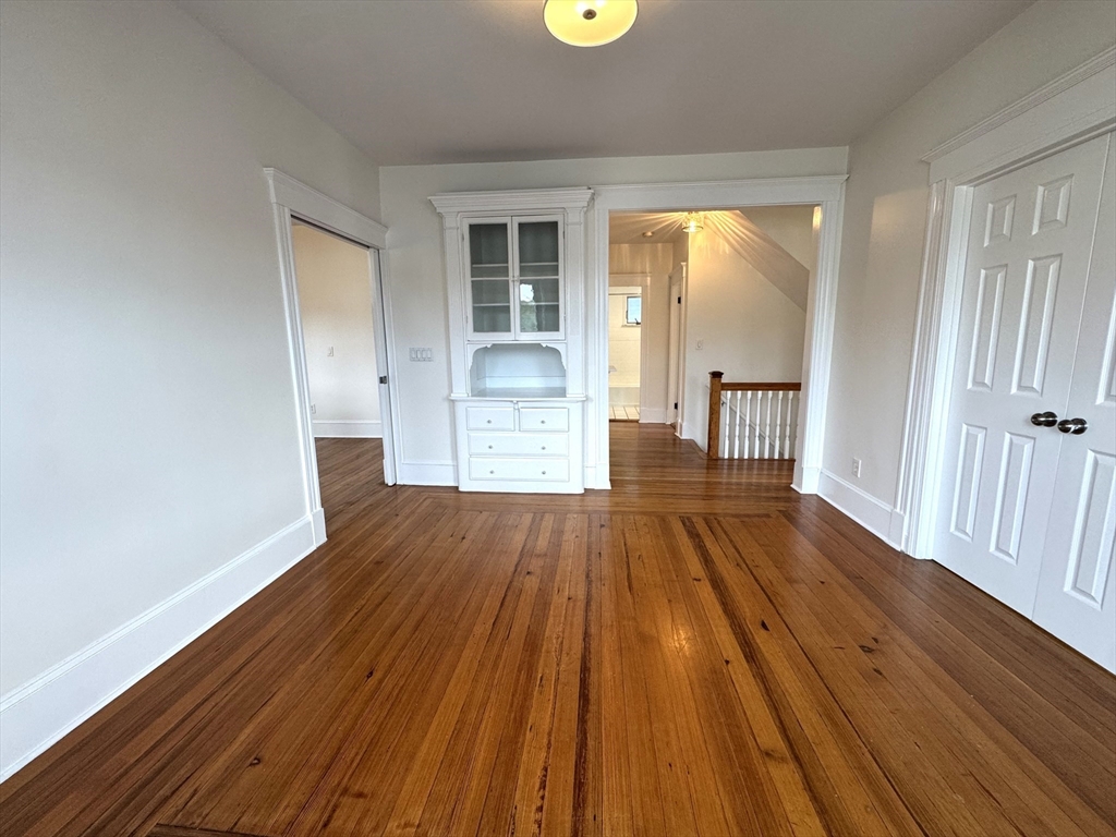 14 Breck Avenue, Unit 2 Boston, MA 02135 - Photo 6 of 26 wooden floor in an empty room with a window