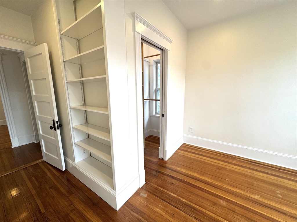 14 Breck Avenue, Unit 2 Boston, MA 02135 - Photo 8 of 26 a view of an empty room with wooden floor and a window
