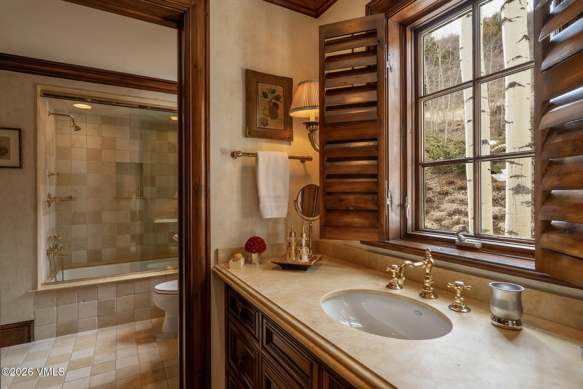 677 Pilgrim Drive Edwards, CO 81632 - Photo 27 of 64 a bathroom with a granite countertop sink and a mirror